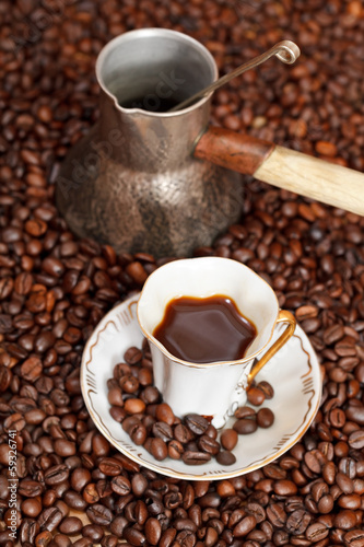 cup of coffee and roasted beans