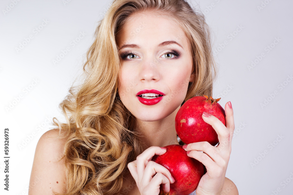 beautiful woman with pomegranates in her hands beautiful woman with pomegranates in her hands