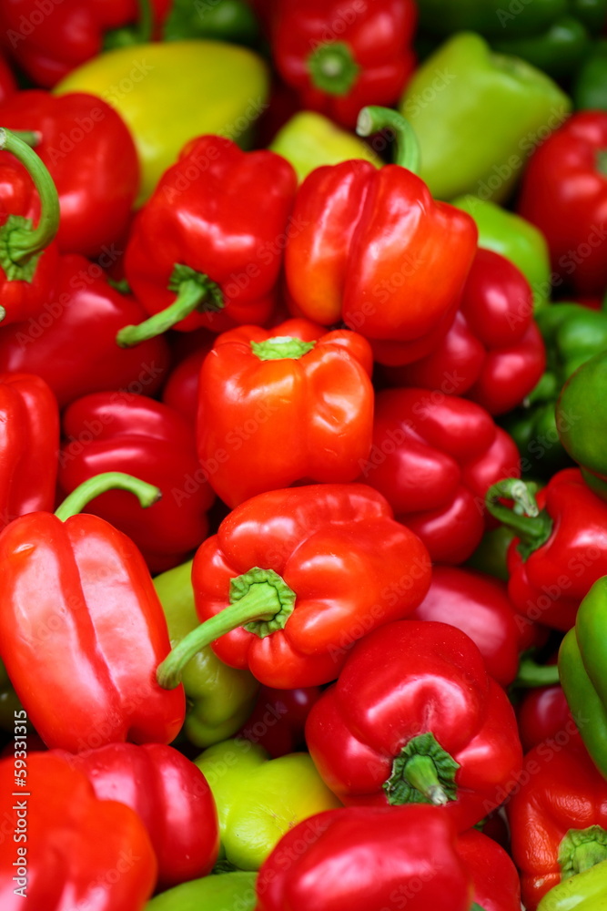 Red, green and yellow sweet bell peppers natural background.
