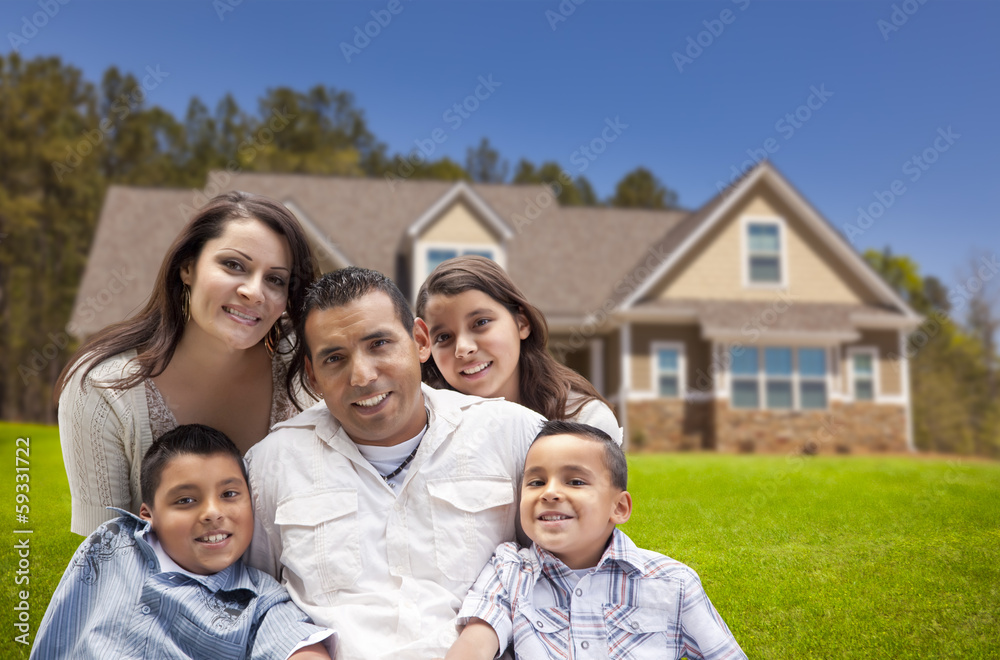 Young Hispanic Family in Front of Their New Home Young Hispanic Family in Front of Their New Home
