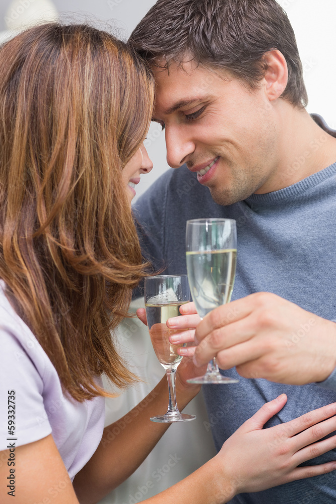 Close-up of a romantic couple with flutes at home Close-up of a romantic couple with flutes at home