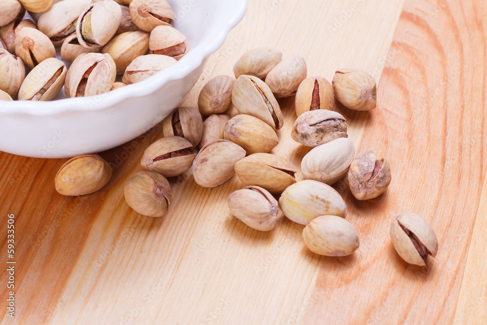 Plate with tasty nuts on the table Plate with tasty nuts on the table