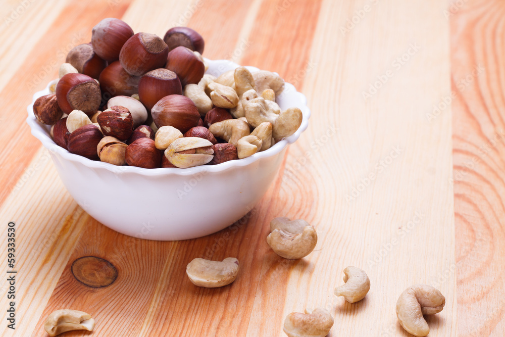 Plate with tasty nuts on the table Plate with tasty nuts on the table