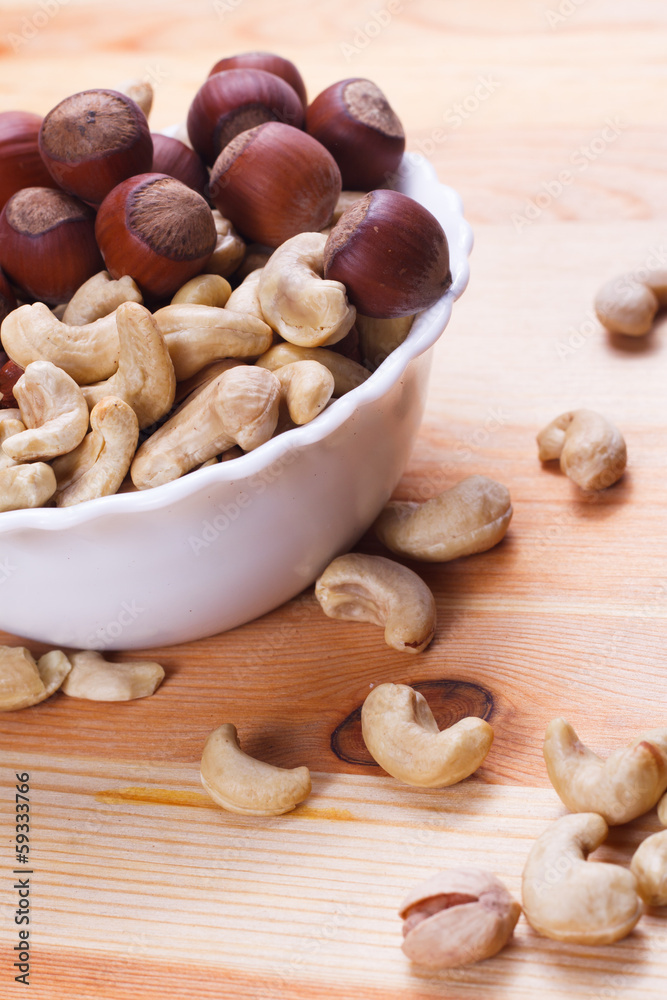 Plate with tasty nuts on the table Plate with tasty nuts on the table
