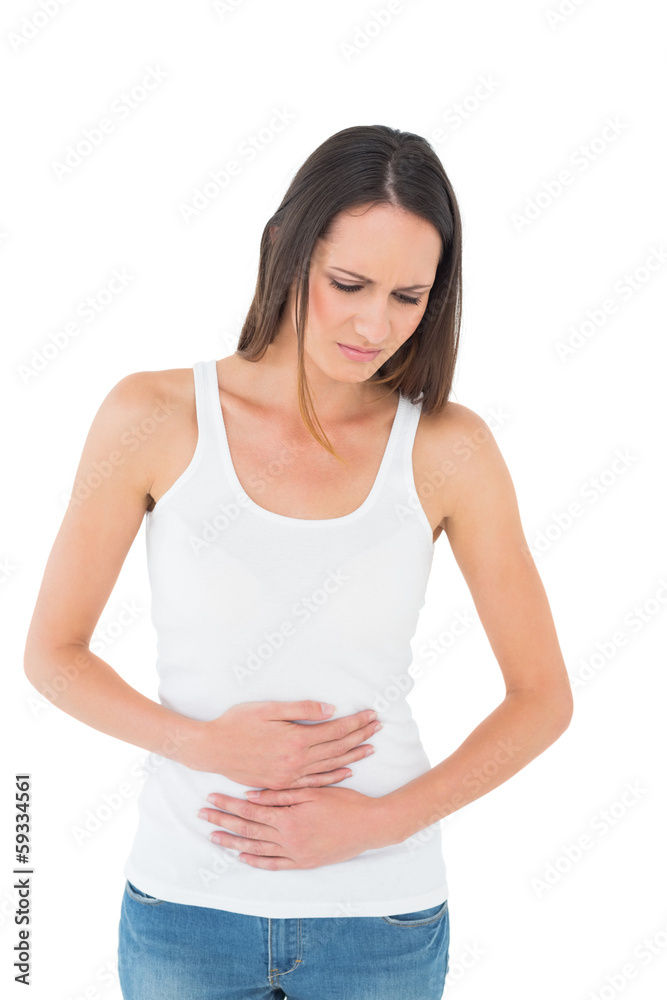 Displeased casual young woman with stomach pain Displeased casual young woman with stomach pain