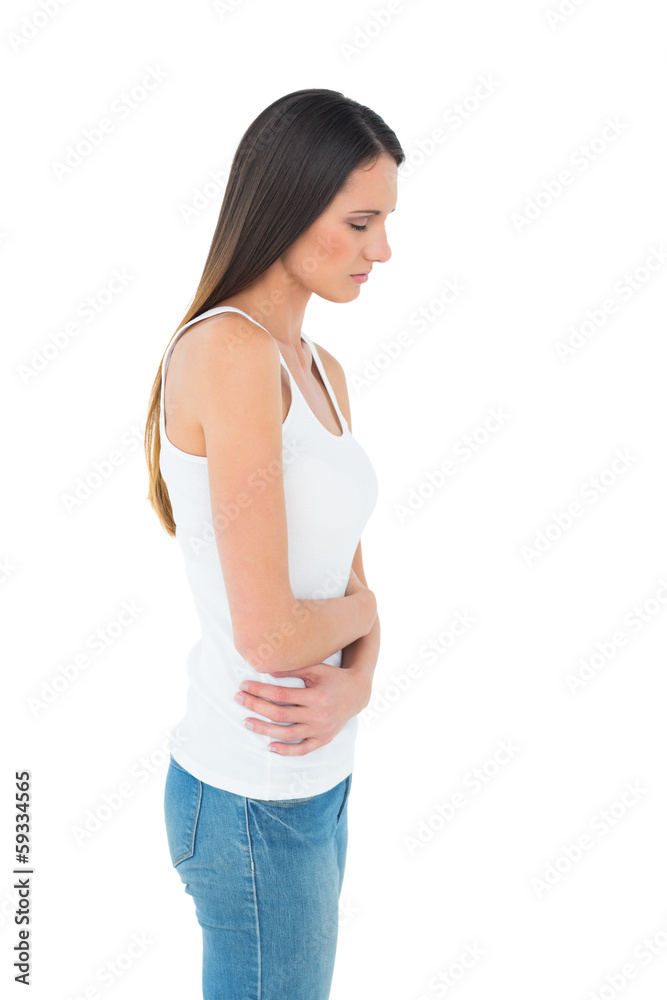 Casual woman with stomach pain and headache Casual woman with stomach pain and headache