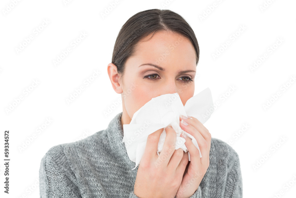 Close-up of a casual young woman suffering from cold Close-up of a casual young woman suffering from cold