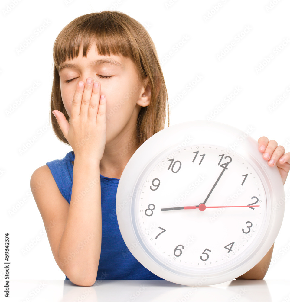 Little girl is holding big clock