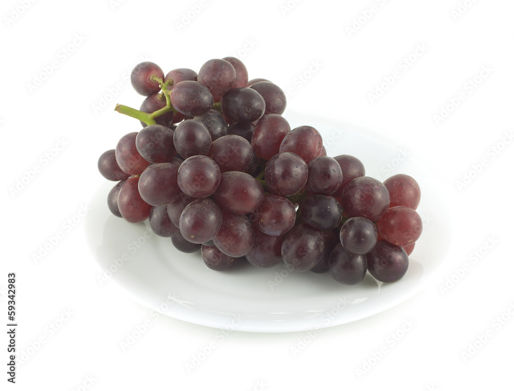 Red wine grape branch with tasty berries on plated isolated Red wine grape branch with tasty berries on plated isolated