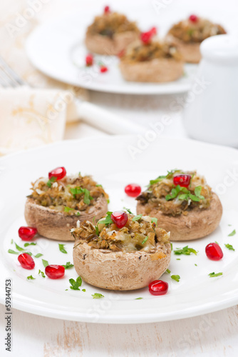 appetizer - stuffed mushrooms with herbs and pomegranate seeds