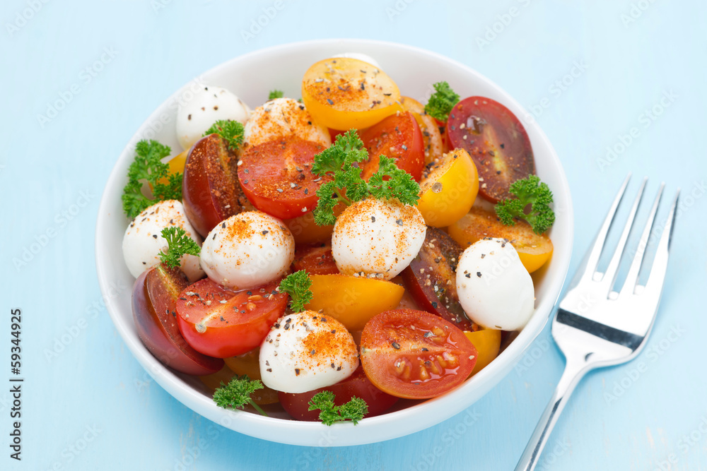 bowl of salad with mozzarella, herb and colorful cherry tomatoes