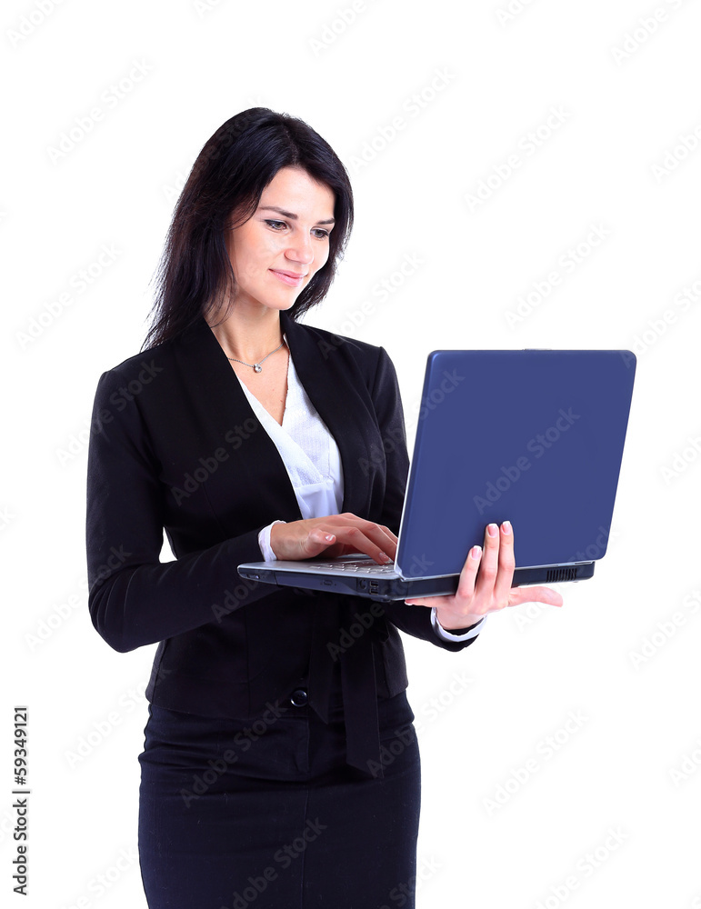 Businesswoman working at a laptop full length Businesswoman working at a laptop full length