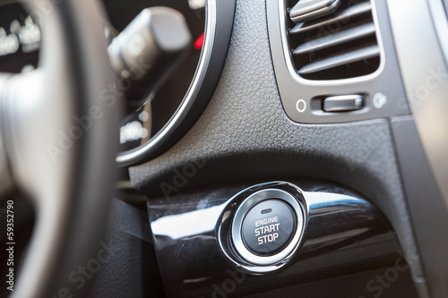 Car interior, engine start button under steering wheel © Kekyalyaynen