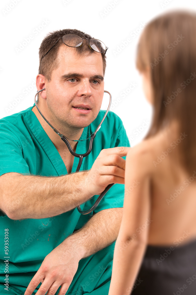Doctor examining little girl in hospital