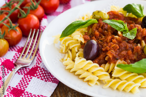 Pasta with tomato souse, olives and basil