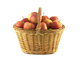 Handmade wicker basket full of ripe apples isolated closeup