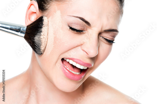 woman with powder on the skin of cheek
