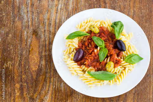Pasta with tomato souse, olives and basil