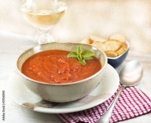 Tomato soup bowl with wine and croutons