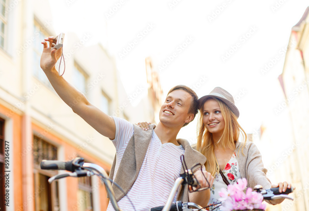 couple with bicycles taking photo with camera couple with bicycles taking photo with camera