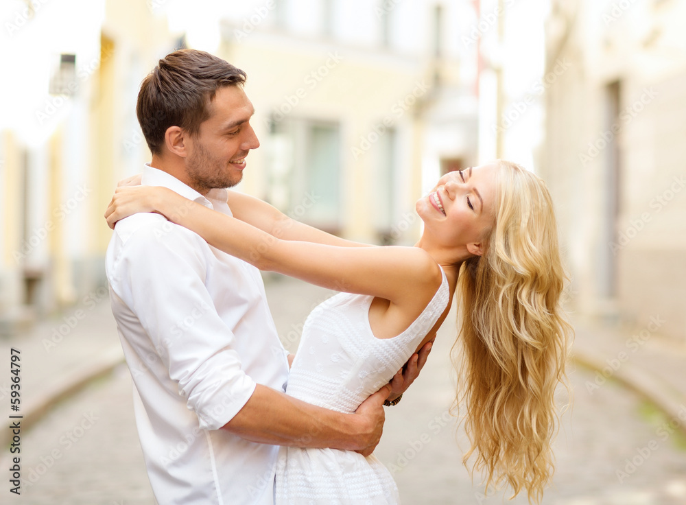 smiling couple dancing in the city smiling couple dancing in the city
