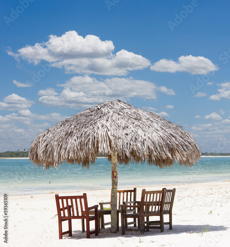 beach chairs under a palapa umbrella in Jericoacoara  Brazil