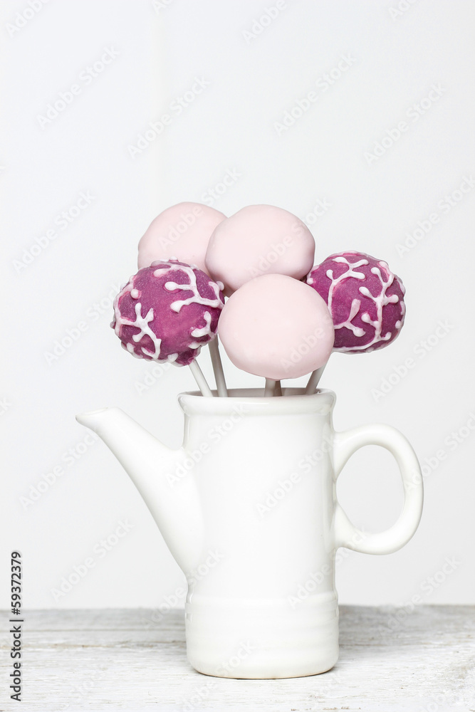 Cake pops in white jug isolated on white background. Copy space Cake pops in white jug isolated on white background. Copy space
