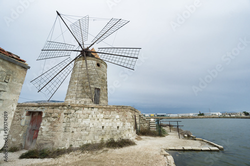 salina windmill in Trapani, Sicily, Italy.