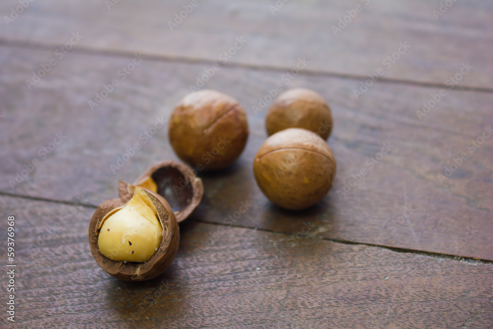macadamia nuts on wood background macadamia nuts on wood background