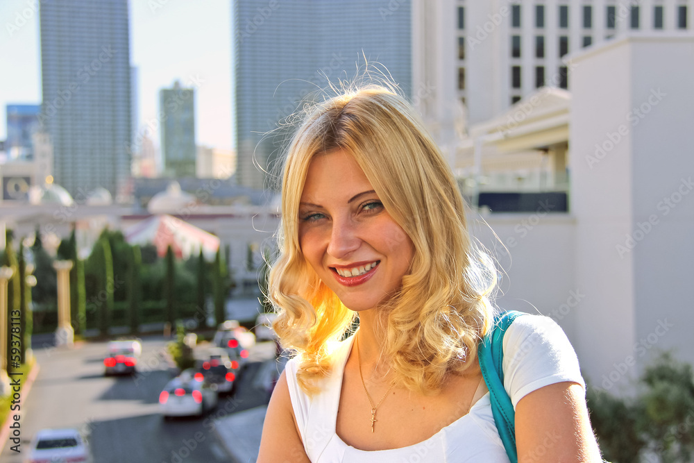 Smiling blonde girl in a summer town Smiling blonde girl in a summer town