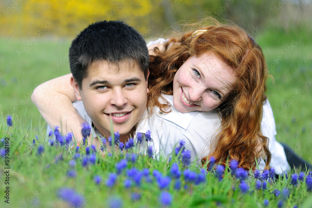 beautiful young couple in love on a green glade beautiful young couple in love on a green glade