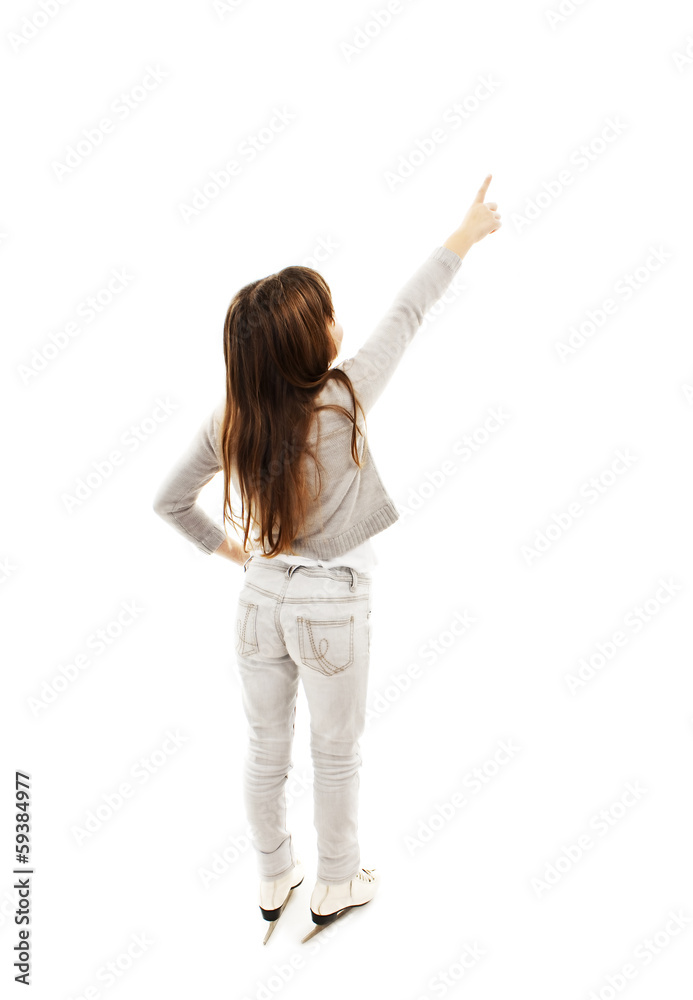 Back view of little girl with ice skates, points at wall Back view of little girl with ice skates, points at wall