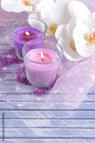 Beautiful colorful candles and  orchid flowers 