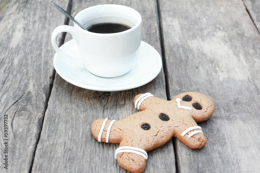Gingerbread man with coffee on wood Gingerbread man with coffee on wood