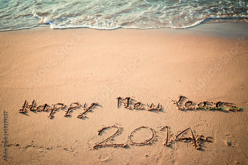 Writing Happy New Year's 2014 on the Beach in Thailand