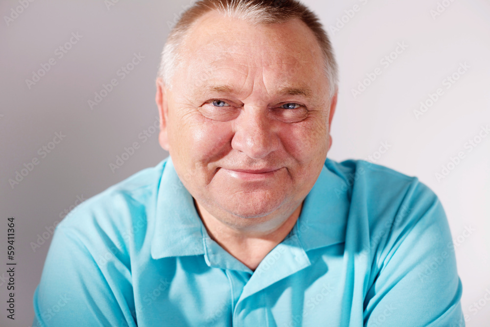 Smiling senior man closeup over white Smiling senior man closeup over white