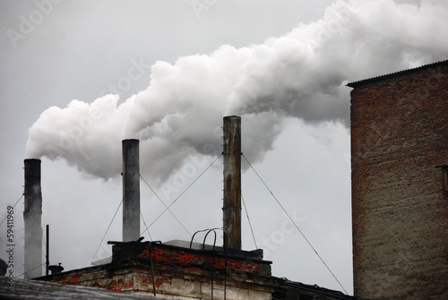 Canvas Print three smoking factory chimneys