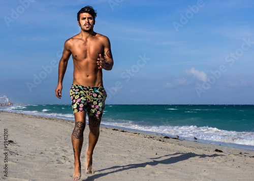 man running on the beach, in Miami beach © oneinchpunch
