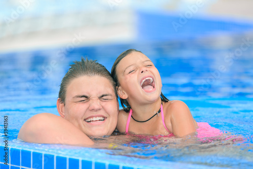 happy  smiling children play in the swimmig pool © Vit