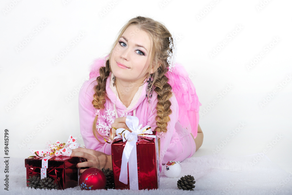 The young beautiful girl an angel with gifts The young beautiful girl an angel with gifts