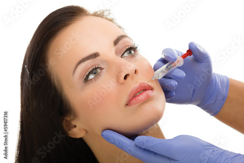 Cosmetic injection in woman's cheek photo