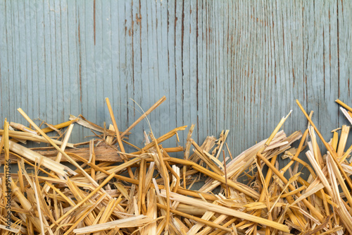 hay against an old blue wooden wall