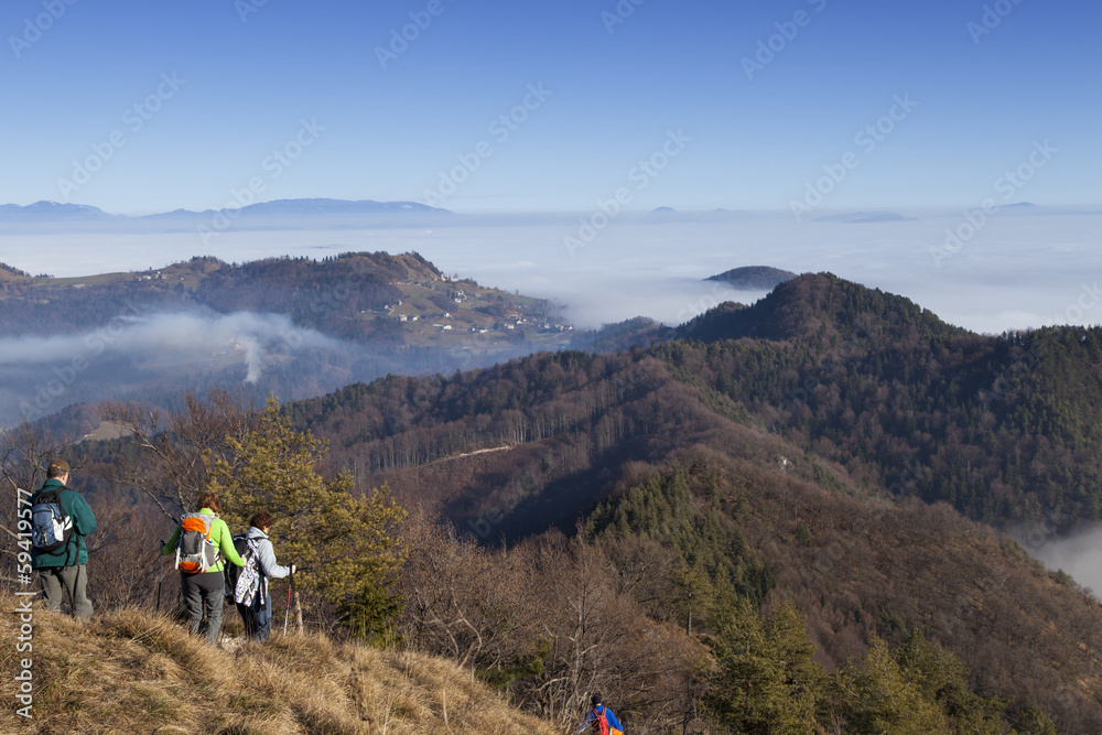 Mountain hikers on return to foggy walley