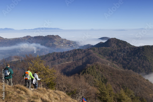 Mountain hikers on return to foggy walley