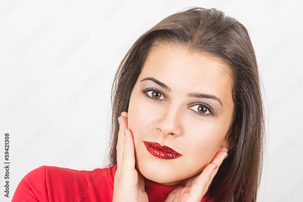 Pretty young woman with red sequins on her lips Pretty young woman with red sequins on her lips