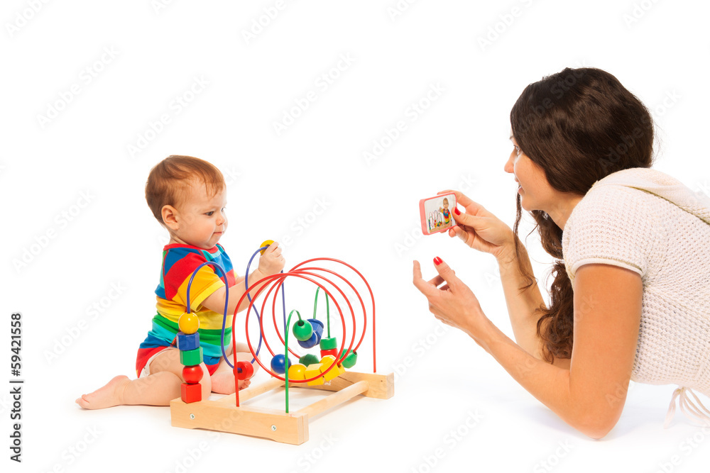 Photograph baby playing