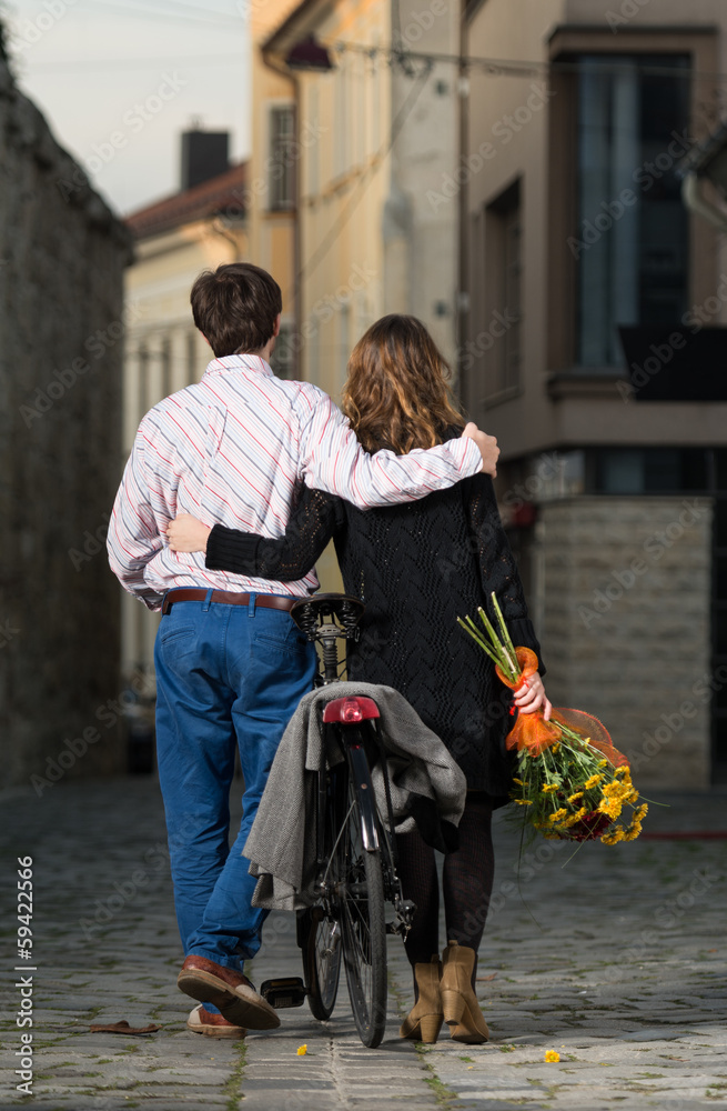 young man and woman walking away together