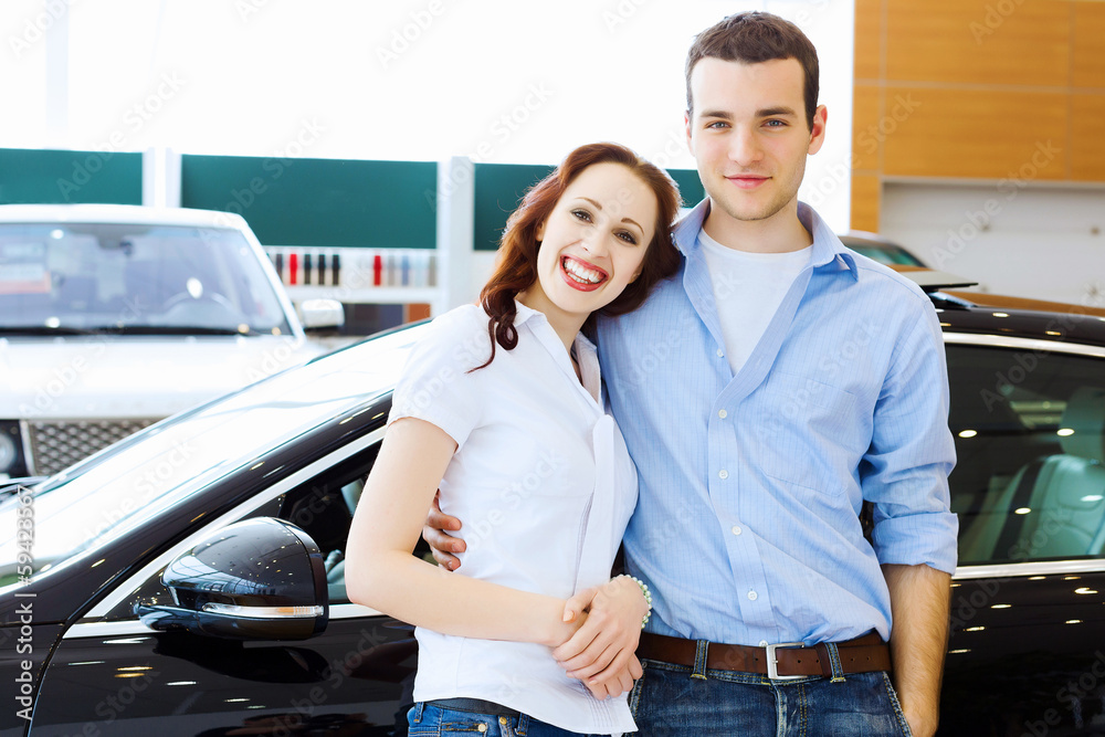 Young happy couple at car salon Young happy couple at car salon
