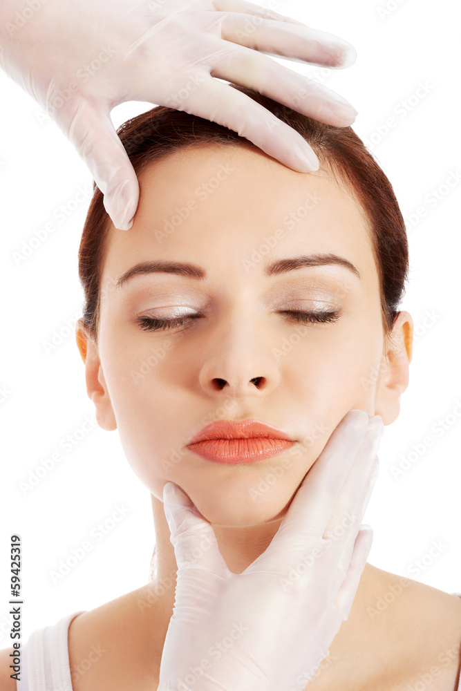 Beautiful woman's face is prepared to medical surgery.