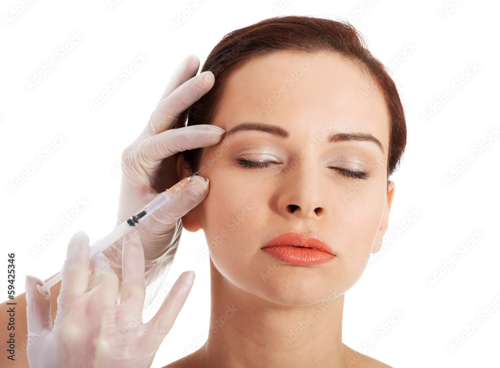 Beautiful woman's face is prepared to medical surgery.